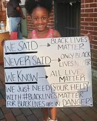 A little girl holding a sign